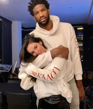 Christine Embiid son Joel Embiid with his girlfriend Anne De Paula.